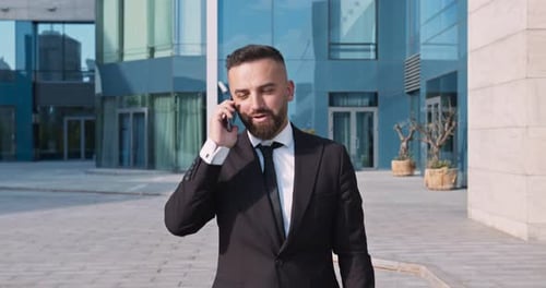 Businessman Talking on Cell Phone Outside Office Building