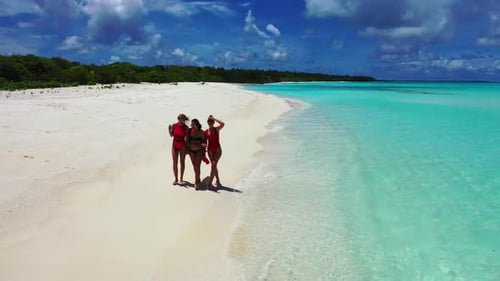 Ladies posing on tranquil coastline beach adventure by blue lagoon with white sandy background of th