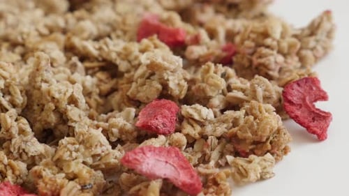 Tasty muesli with dehydrated strawberries slow pan 4K 2160p 30fps UltraHD footage - Healthy pile of