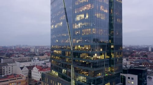 Skyscraper Late Evening with People Working Late Into the Glass Windows Offices