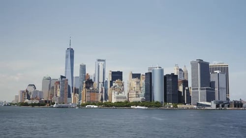 The Financial District of Manhattan, with the One World Trade Center on a sunny day with blue skies,