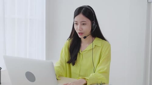 Young Adult Waving During Remote Video Meeting