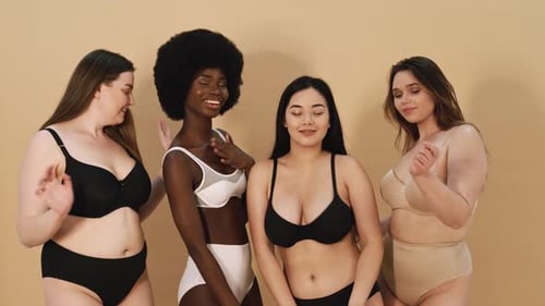 Diverse Women Posing in Lingerie on Tan Background