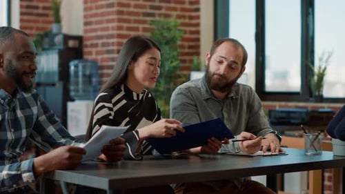 Smiling Team Interviewing Job Candidate in Modern Office