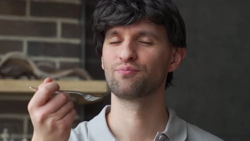 Closeup of a Man Eating Food with a Fork
