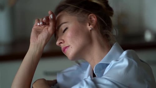 Woman Resting Head in Hand Indoors