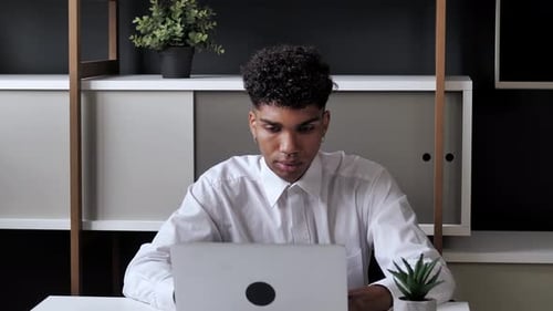 Man Working at Computer in Modern Office Setting