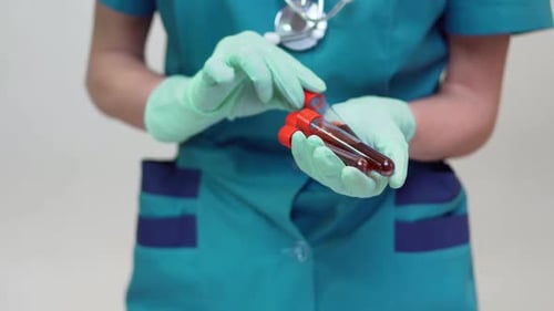 Medical Professional Analyzing Blood Samples in Test Tubes