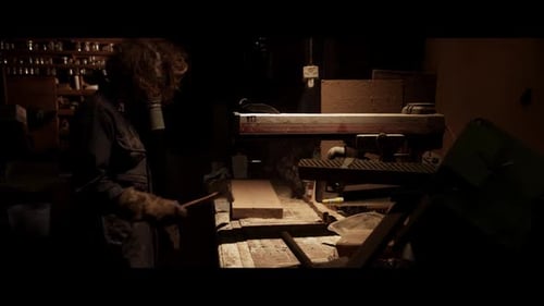 Man in Gas Mask Works in Dark Workshop