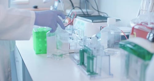 Scientist Carefully Using Pipette in Modern Laboratory