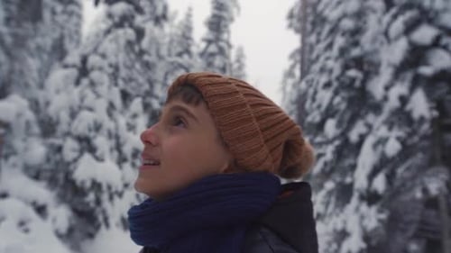Boy alone in the forest in winter.