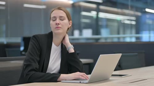 Woman Experiencing Neck Pain at Office Workplace