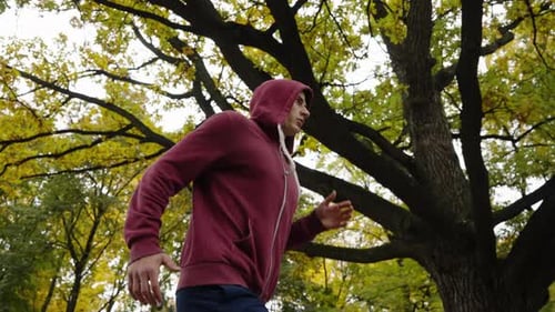 Man Jogging in Autumn Park