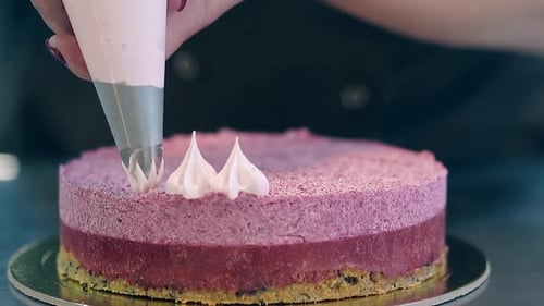 Cake being Decorated with Sweet Frosting