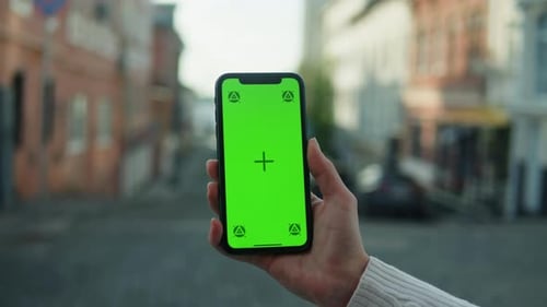 Woman Holding Smartphone with Chroma Key Closeup