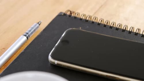 Cellphone, Notebook, Pen and Coffee Cup on Desk