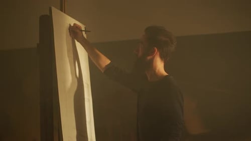 Young Adult Man Drawing on Canvas Indoors