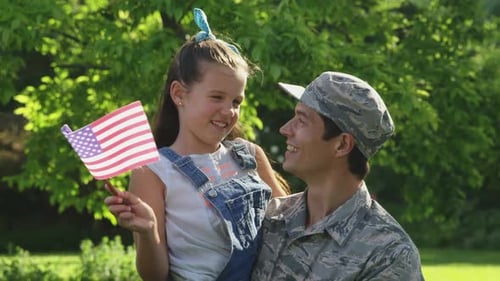 Proud Military Dad Holding Daughter With American Flag
