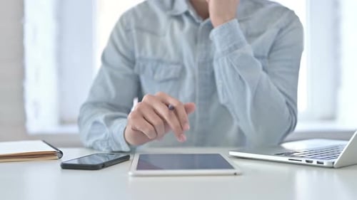 Close Up of Young Guy Hands Working on Tablet in Office