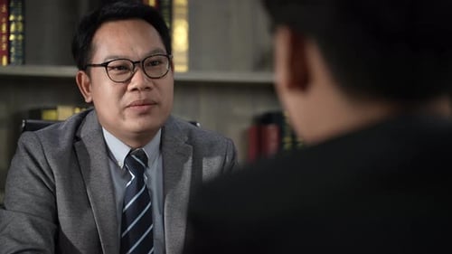 Executives talking to business people at their desks in the office