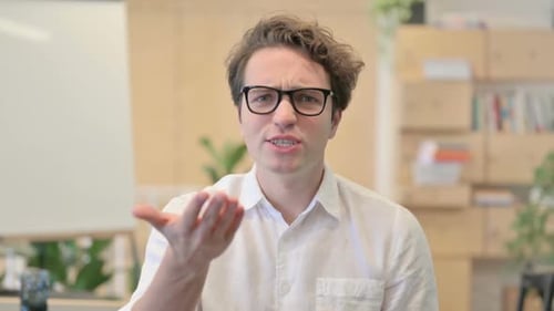 Young Adult Talking and Gesturing in Office