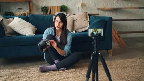 Woman Reviews Virtual Reality Goggles at Home