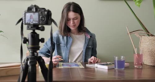 Artist, Teenage Girl, Draws and Records on Video Camera for His Blog