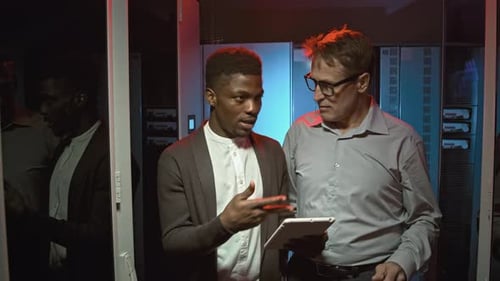 Colleagues Talking and Walking through Data Center