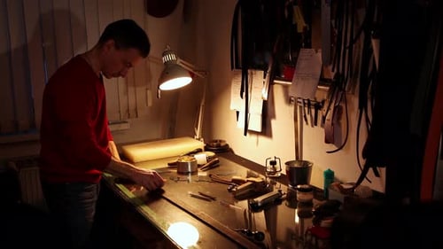 Tailor Polishes a Piece of Leather for the Belt in His Personal Workshop