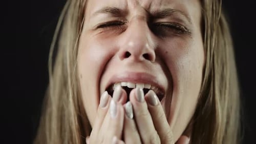 Distraught Woman Crying with Hands to Face