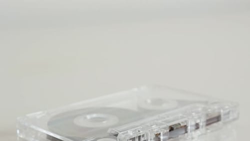 Tilting over analogue magnetic audio tape on white 4K 2160p 30fps UltraHD footage - Close-up of ret