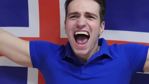 Man Cheering in Front of Flag