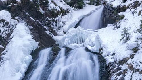 Snowy Waterfall in Winter Mountain Landscape