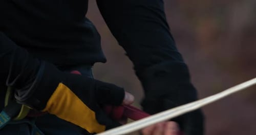 Slackliner is Adjusting the Knots on His Belt Preparation Close Up