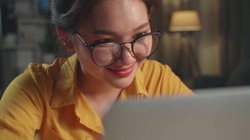 Close Up Girl Doing Homework Or Working With Laptop Computer At Home In Evening