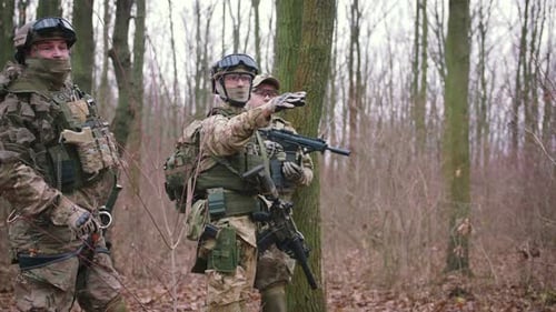 Group of Armed Young Soldiers in a Zone of Armed Conflict in Uniform Targeting with Assault Rifles