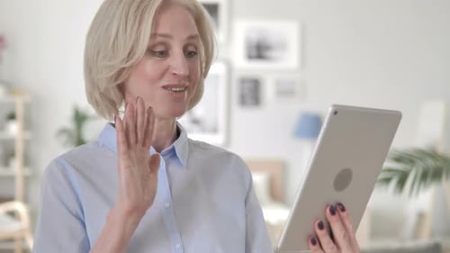 Woman Waving During Video Call on Tablet