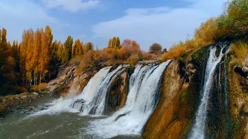 Waterfall Cascades Through Autumnal Nature Landscape From Above