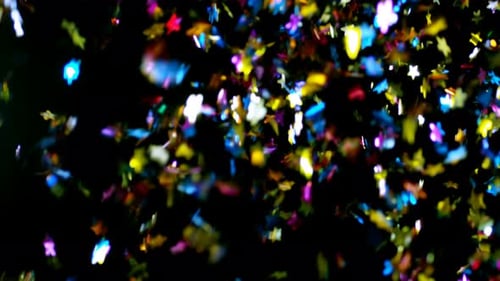 Colorful Star Confetti Falling Against Black Background