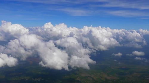 Aerial View of Fluffy Clouds Against a Blue Sky