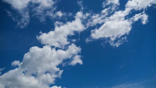 White Clouds Float in Bright Blue Sky