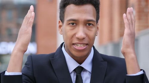 Furious Man Talking and Gesturing in Dark Suit