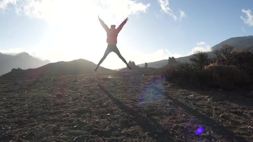 Sporty Happy Girl Tourist Hiking To Cliff of Low Mountain, Bounces and Spreads Her Arms To the Side