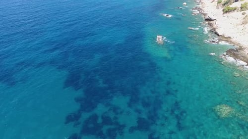 Aerial Clear Reef and Rocky Untouched Coastline of Bright Turquoise Sea