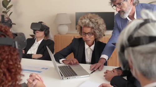 Team Using VR Headsets in Business Meeting