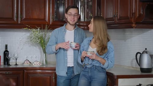 Couple Enjoying Coffee Together in Modern Kitchen