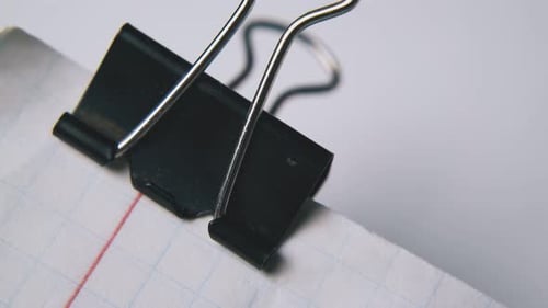 Close up of Binder Clip on Graph Paper