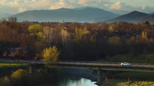 Car Passing By on a Bridge At Sunset
