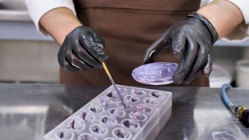 Filling Seashell Candy Mold with Purple Melted Chocolate