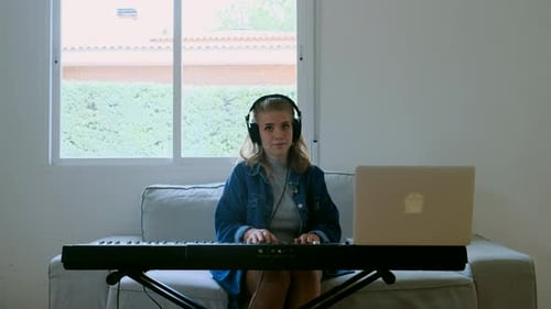 Blonde Woman Plays Keyboard at Home